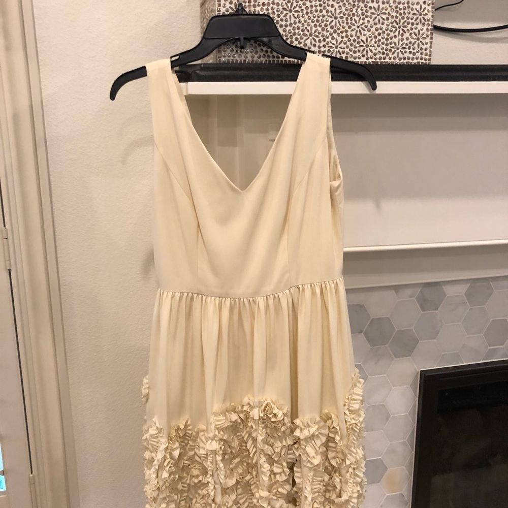 Minuet elegant cream ruffle bottom dress